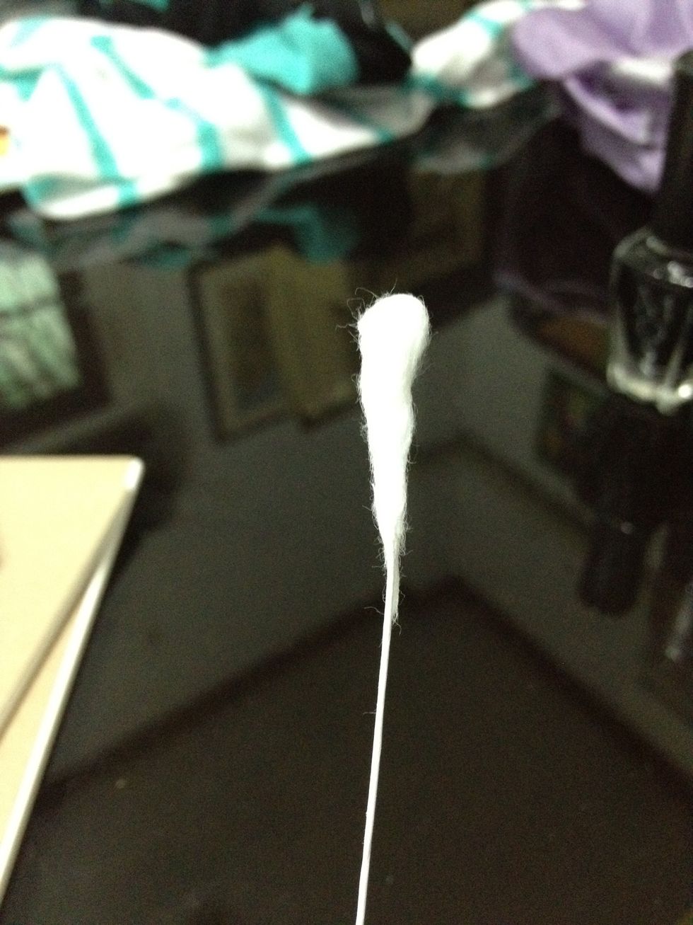 Spin the wire so that the cotton sticks to it.