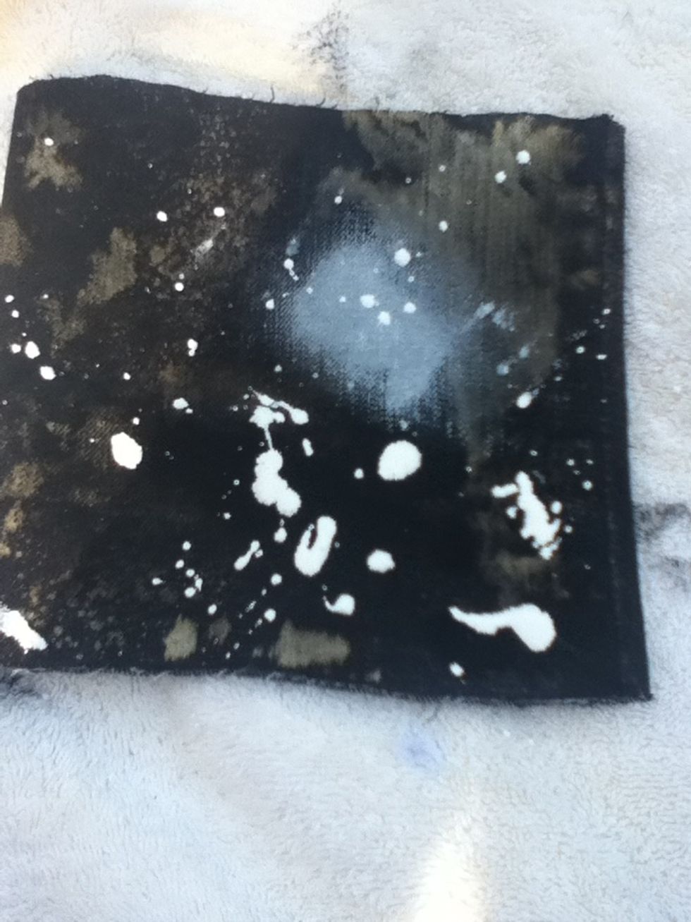 Splatter some white paint (don't worry, it doesn't have to look perfect) you can also smudge some white on there to look like galaxies.