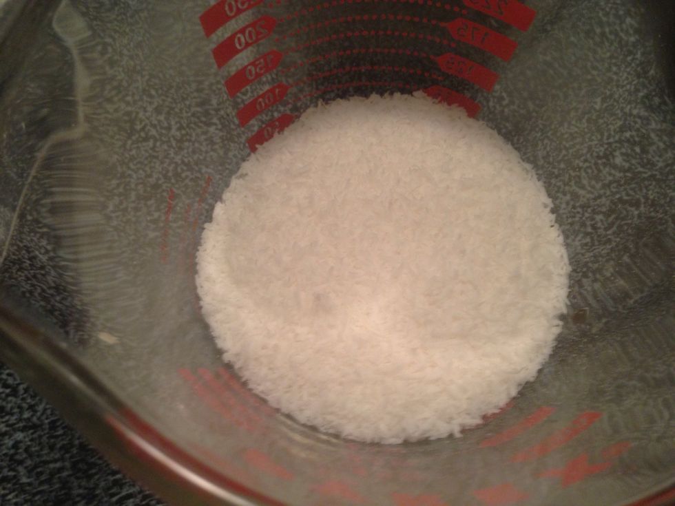 Split 1/2 cup of unsweetened shredded organic coconut in half. Set aside half for later use.