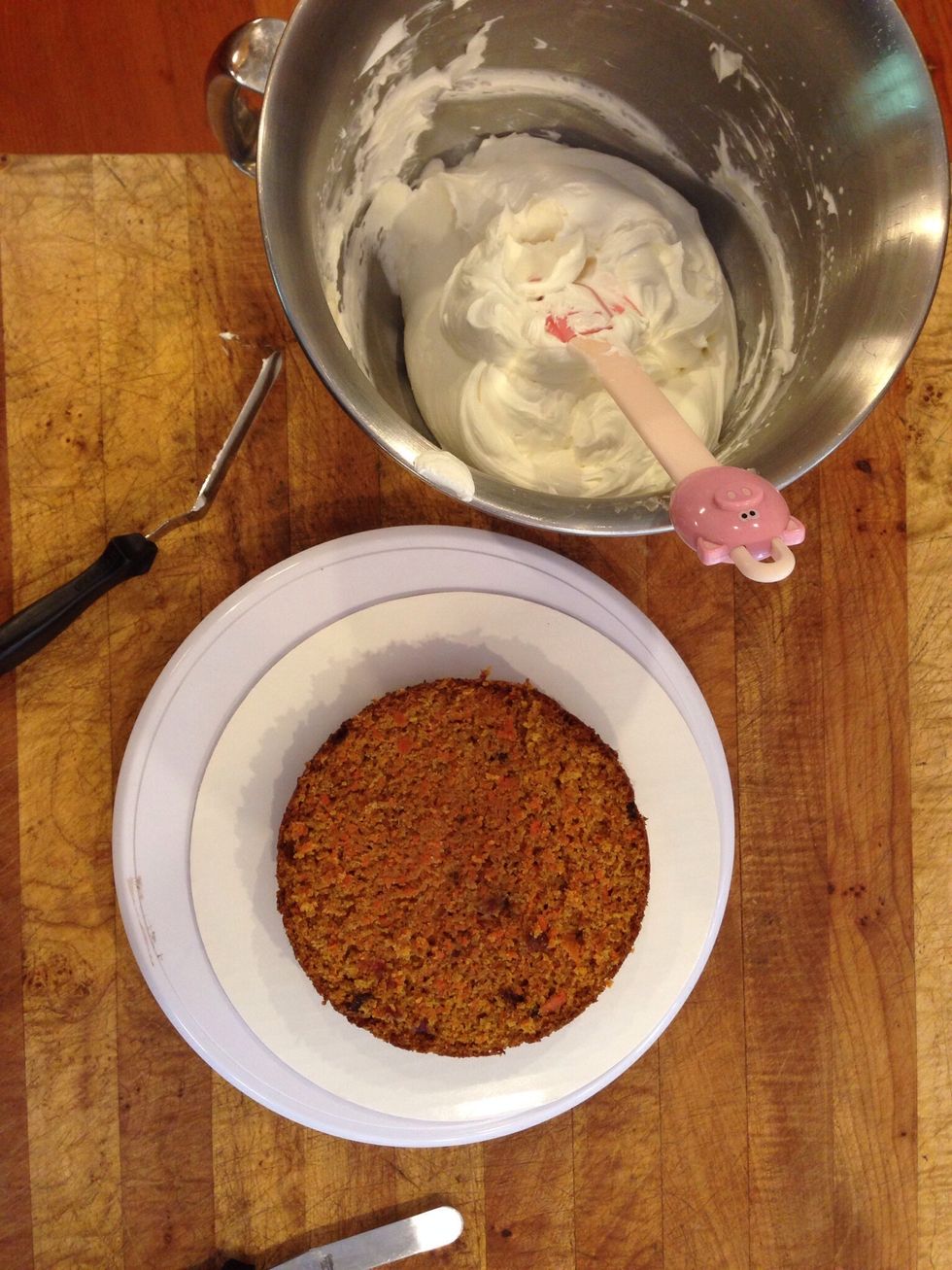 Split each cake in two using a serrated knife, begin by placing one half on a cake board and use your favorite cream cheese frosting recipe as filling.