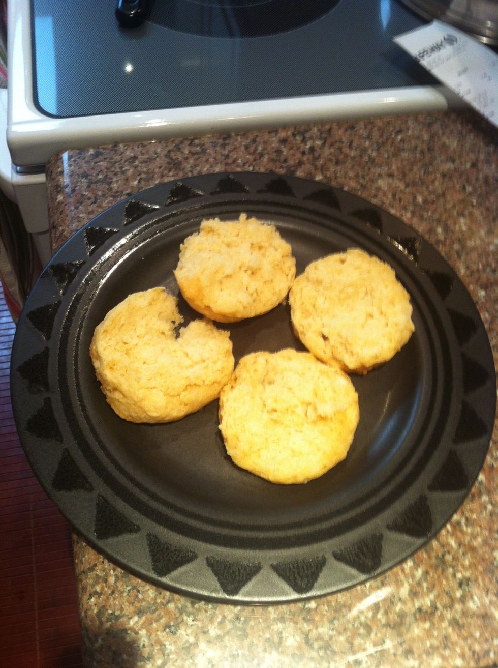 Split open two biscuits and place them face-up on a plate.
