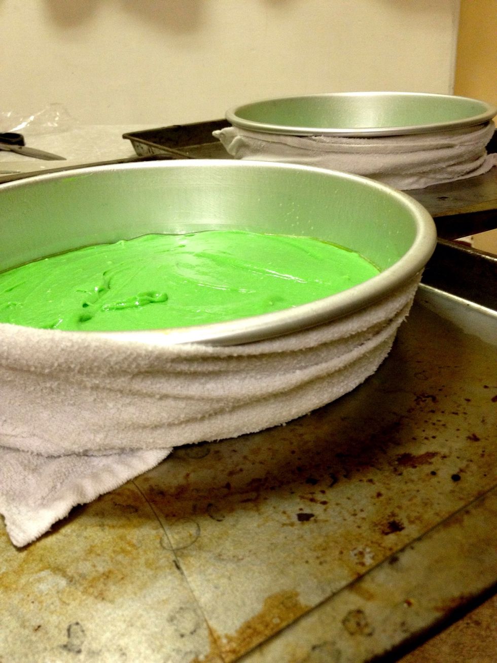 Split the batter into two pans. One of the best tips I learned from Pinterest... Cut an old towel into strips. Wet it. Wrap around your cake pan. Magic!! Your cake will come out level.