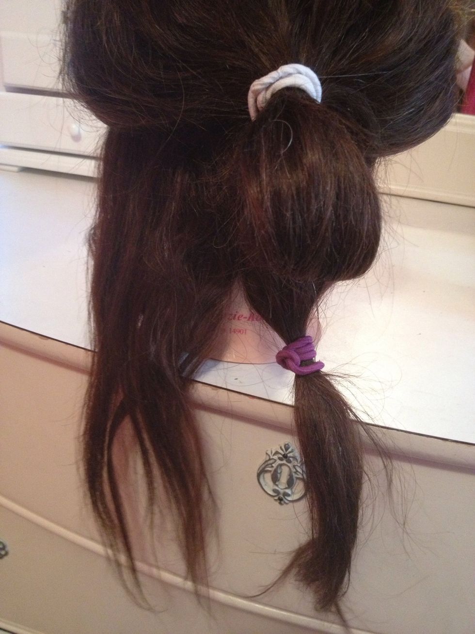 Split the bottom section in half and tie one side using a hair tie.