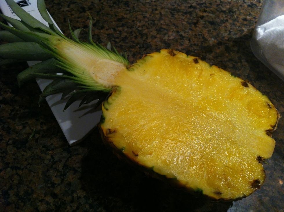 Split the pineapple in half leaving the stem intact