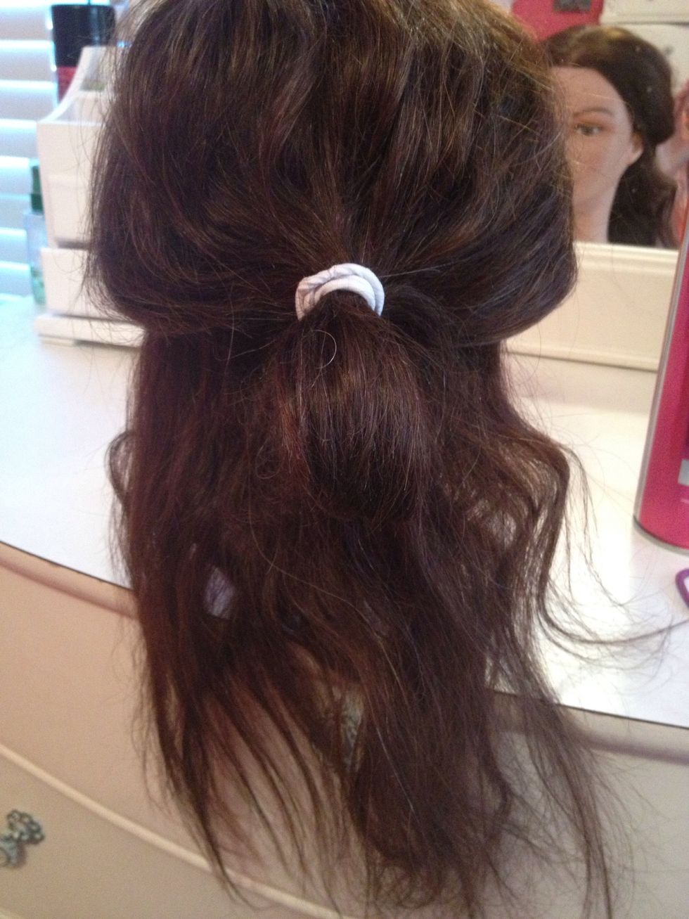Split your hair into 2 sections. (Top & bottom)  Tie the top layer out of the way using a hair tie or clip.