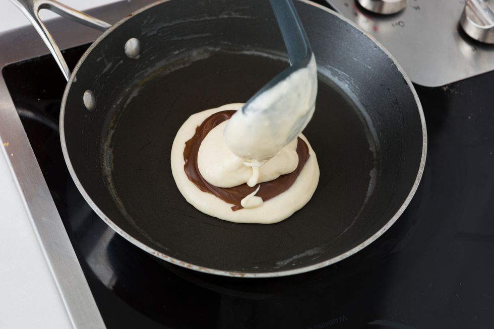 Spoon another 1/4 cup over the disc, completely covering it. Cook for about 2 minutes before carefully flipping.