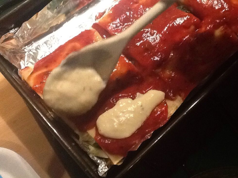Spoon b\u00e9chamel sauce onto cannelloni