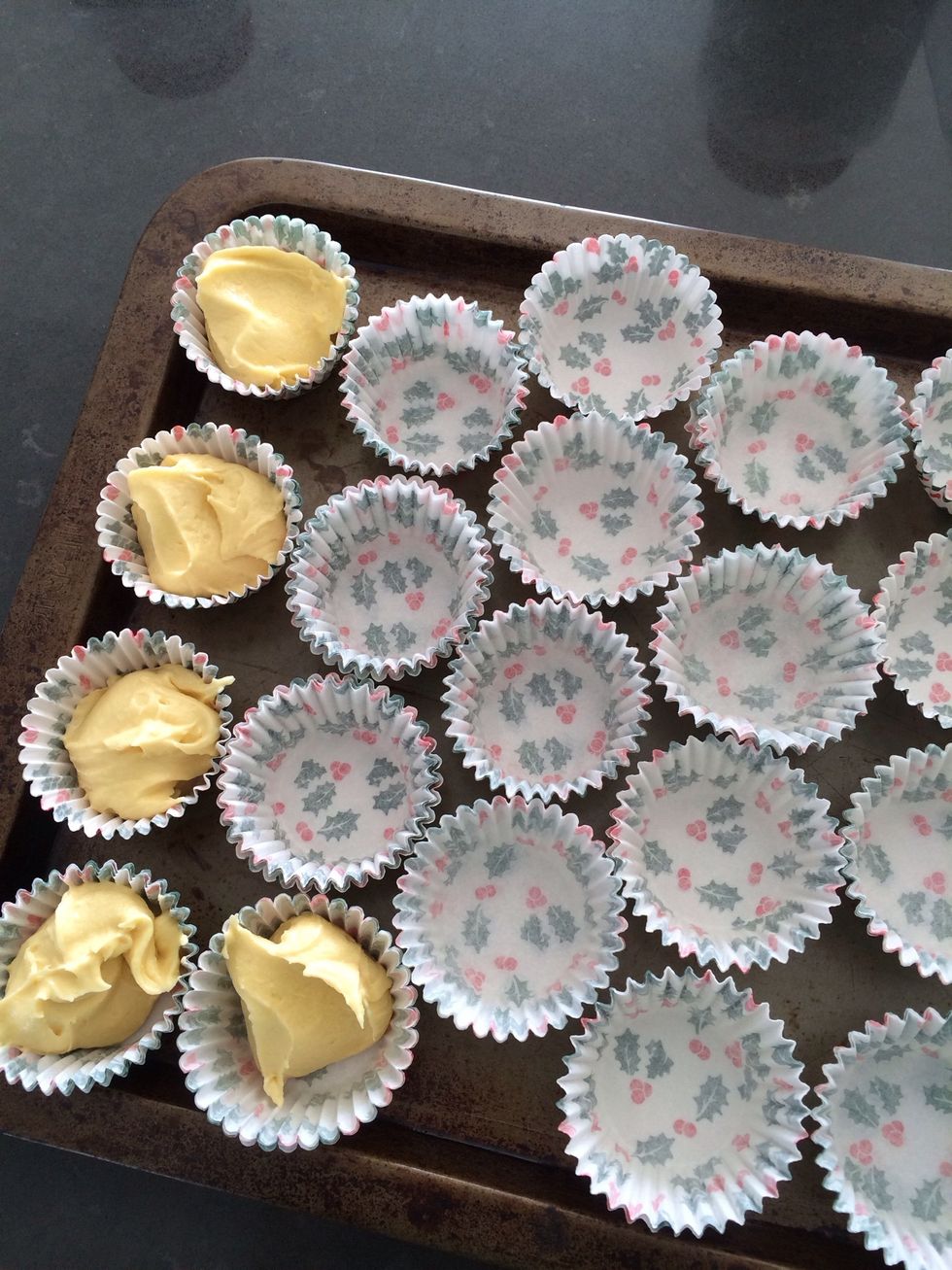Spoon batter evenly into the cups.