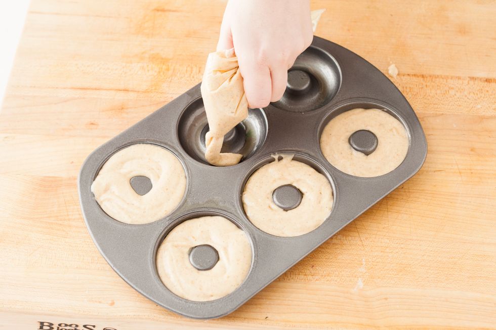 Spoon batter into a large ziploc bag and use a scissor to cut a a corner. Use you makeshift pastry bag to fill each doughnut well to about 3/4 full. Bake for 9-12 minutes and allow to cool on a rack.