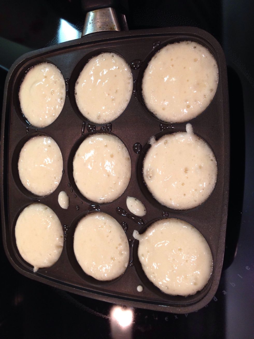 Spoon batter into each cup in the pan, fill just below top edge.