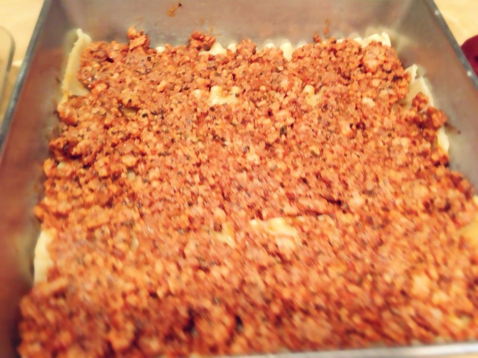 Spoon half the meat mixture on top of the noodles.