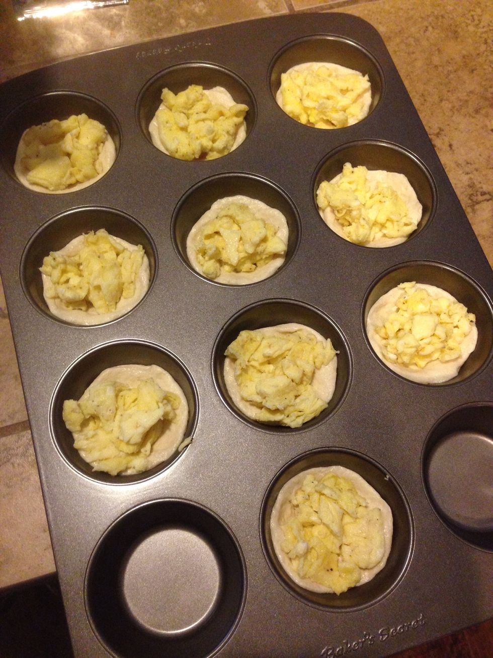 Spoon in eggs into each biscuit bowl