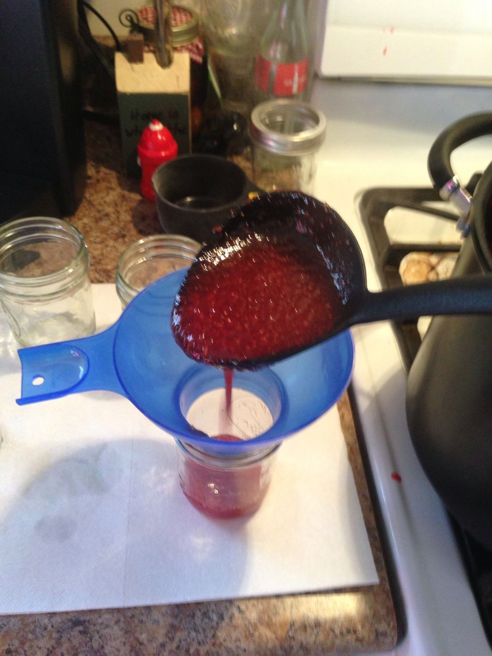 Spoon in the jam. You want to fill it to within 1/4 inch of the lip of the jar. Resist the urge to grab the jar while filling, it's HOT!