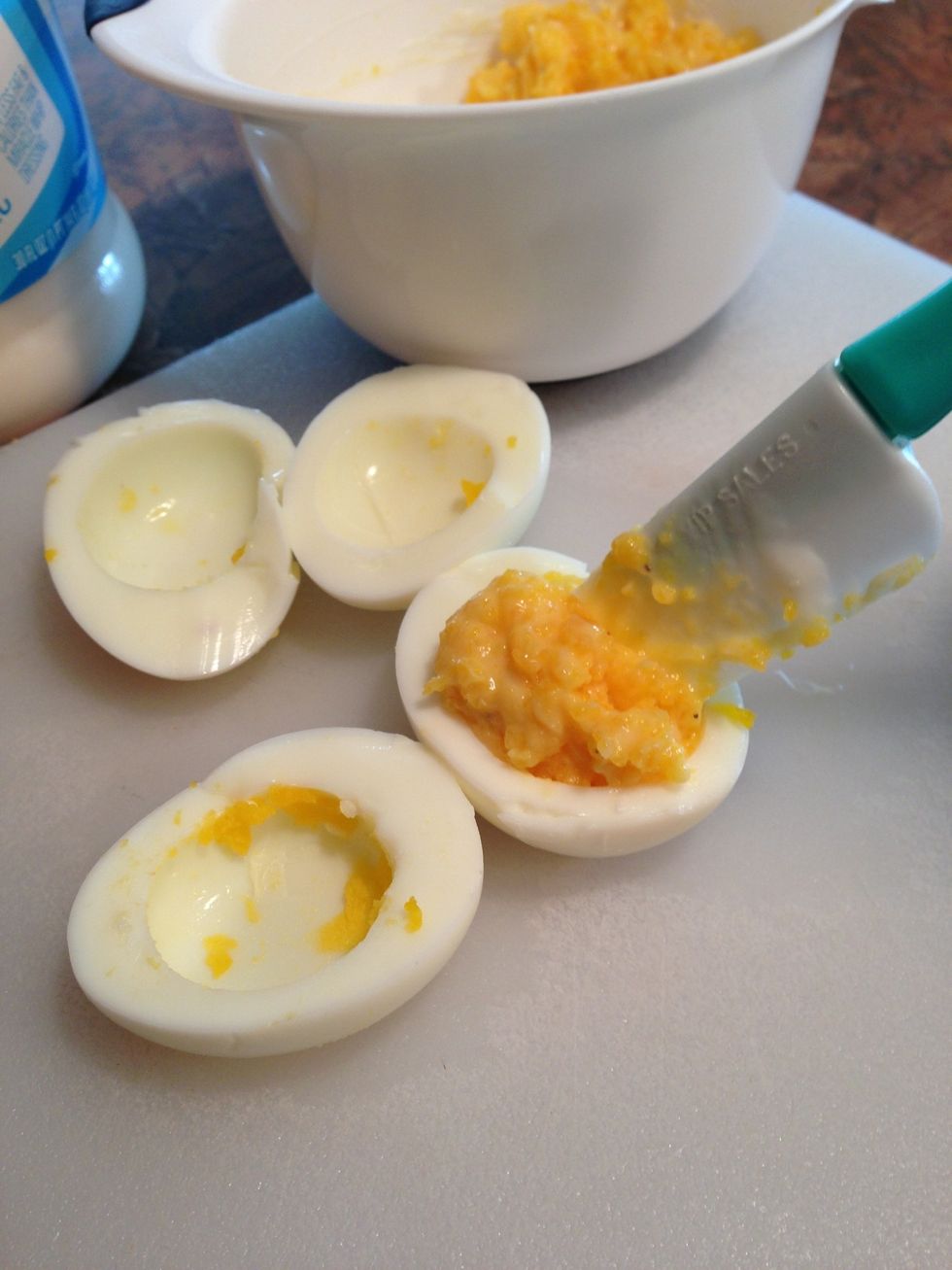 Spoon into egg white halves and mound mixture.