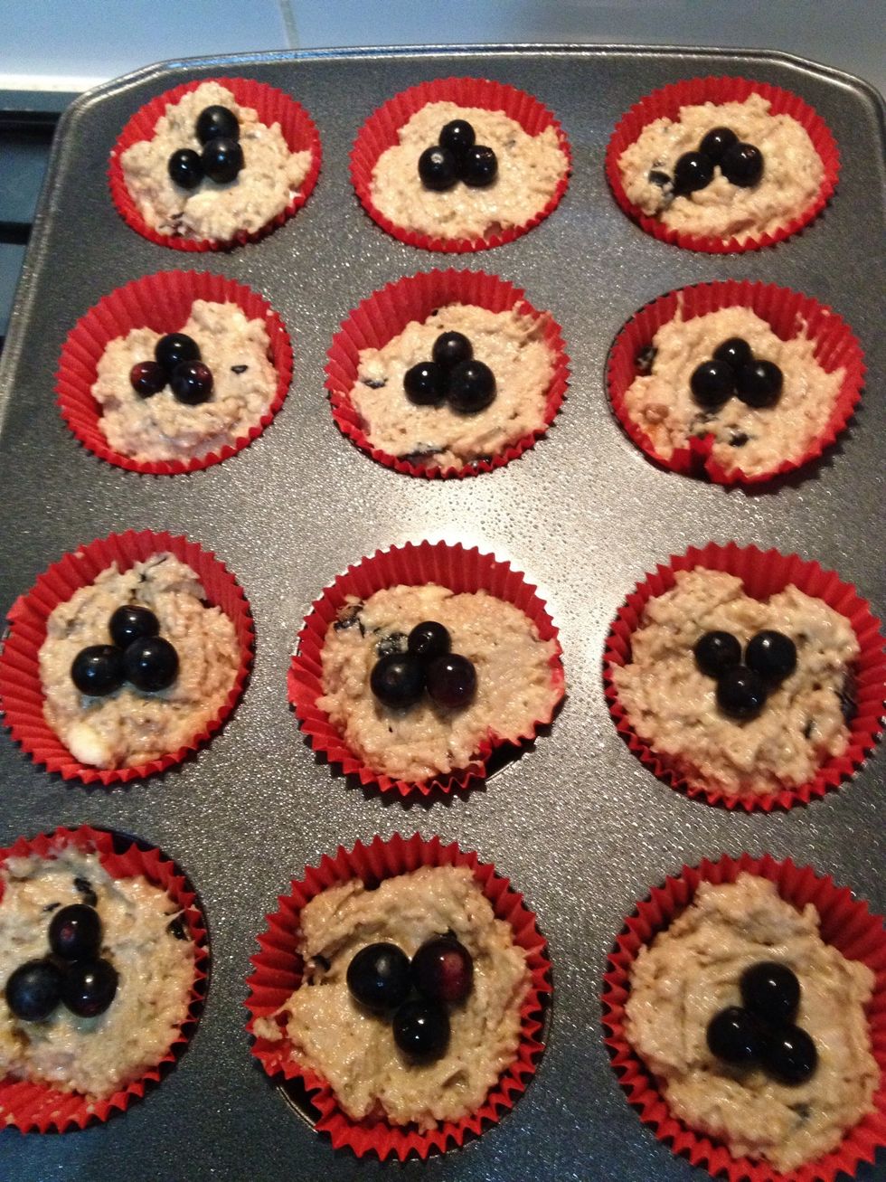 Spoon into paper cases, and top with blueberries as you desire