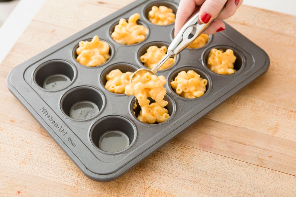 Spoon mac + cheese mixture into your mini muffin tins.
