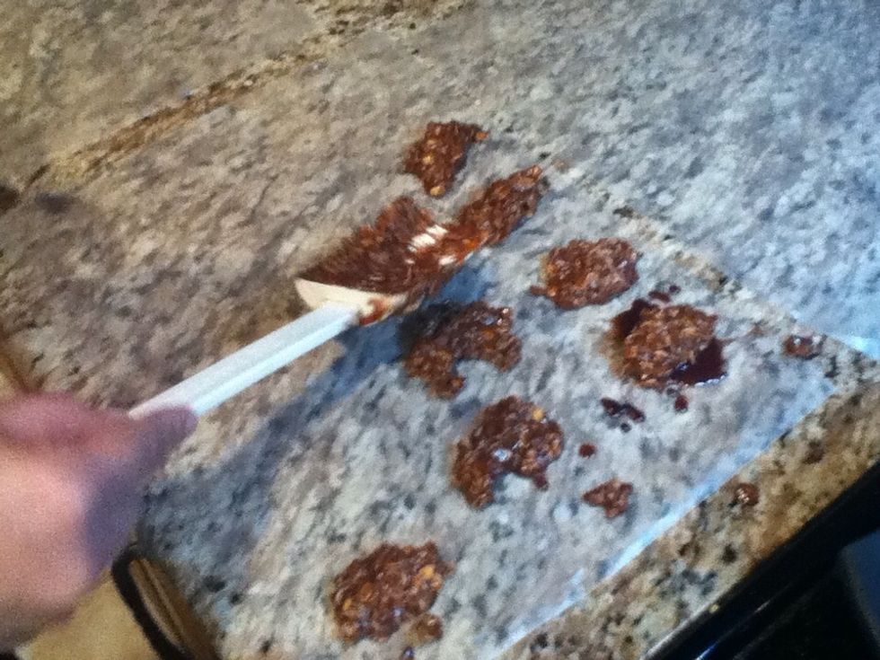 Spoon out 1 to 2 tablespoons onto wax paper (Do this step quickly, the cookies harden fast).