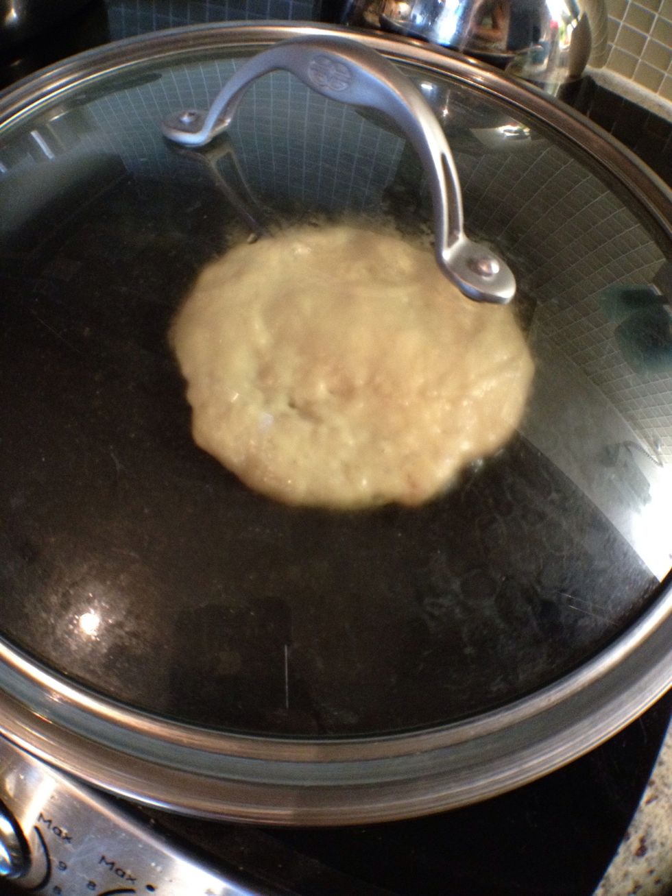 Spoon out about a quarter-cup amount of batter into the pan, smooth out and cook on medium until you see bubbles on the surface (you can cover the pan to get an even heat going).