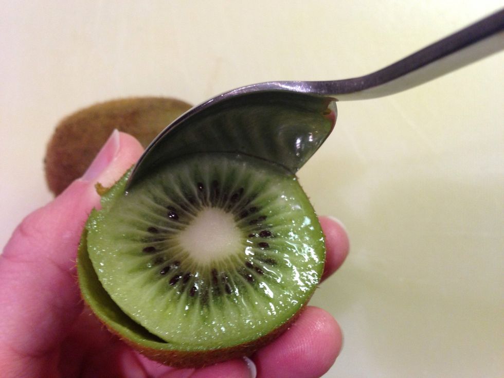 Spoon out fruit.