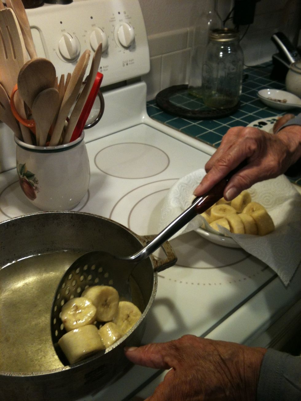 Spoon out slices and lower the heat of the oil. Put slices in a bowl and dap with paper towel.