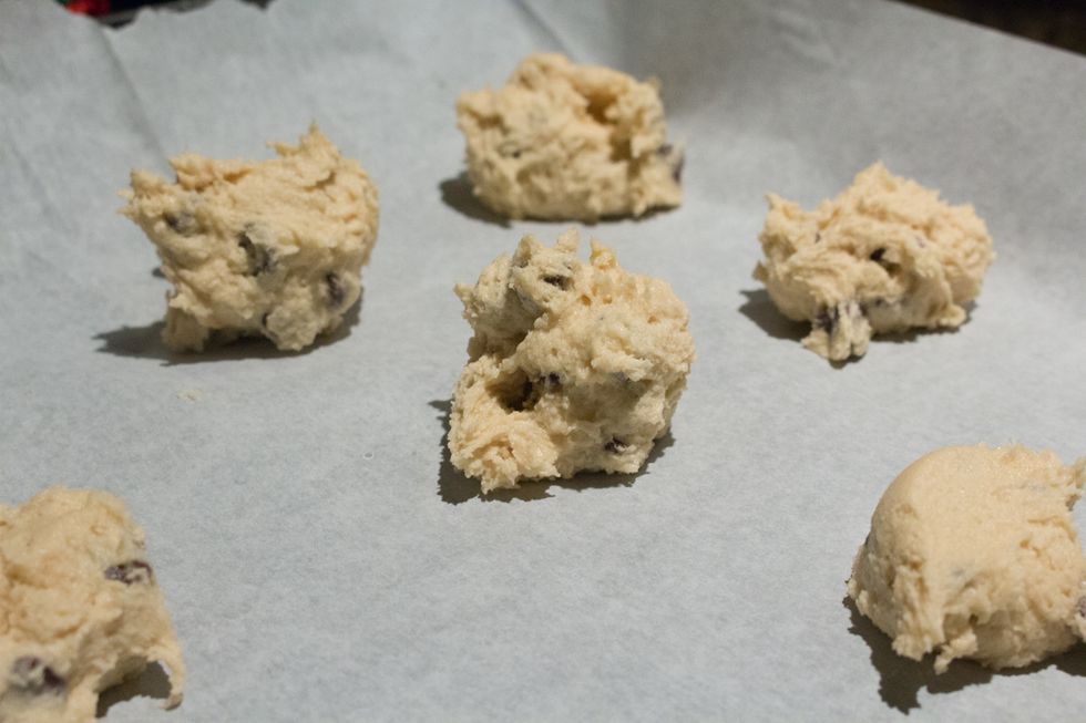 Spoon out the cookie dough tablespoonfuls 2 inches apart on Parchment Paper on a cooke sheet.