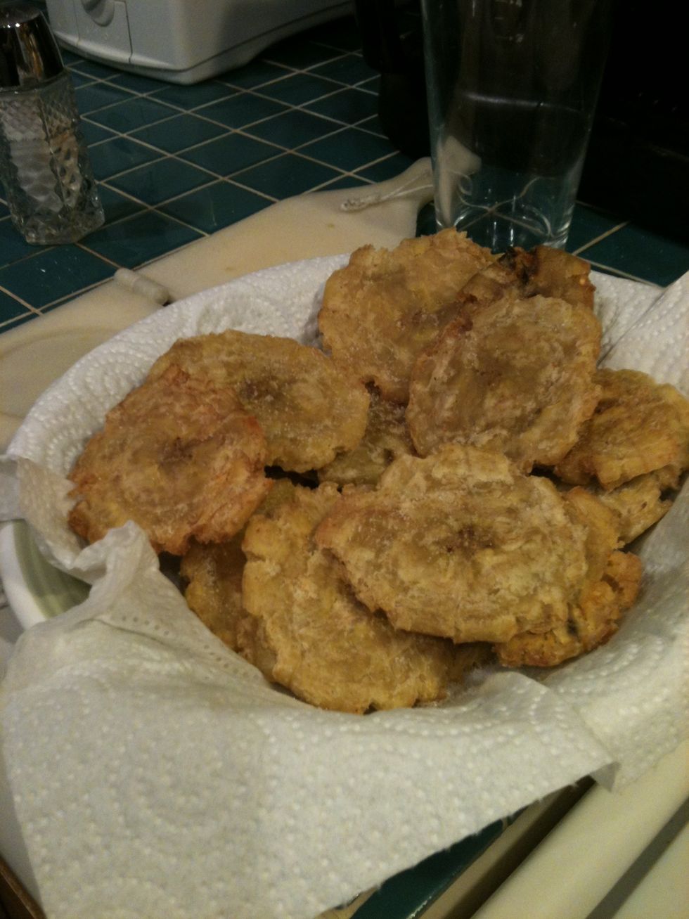 Spoon out tostones, and dry with a paper towel. Add salt. Enjoy.