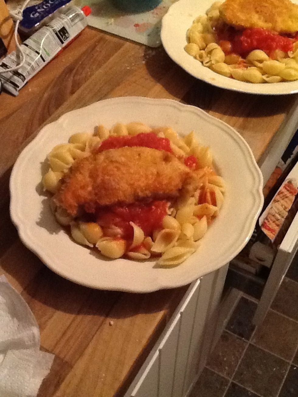 Spoon sauce onto the dish and place the Chicken Parmesan on top!