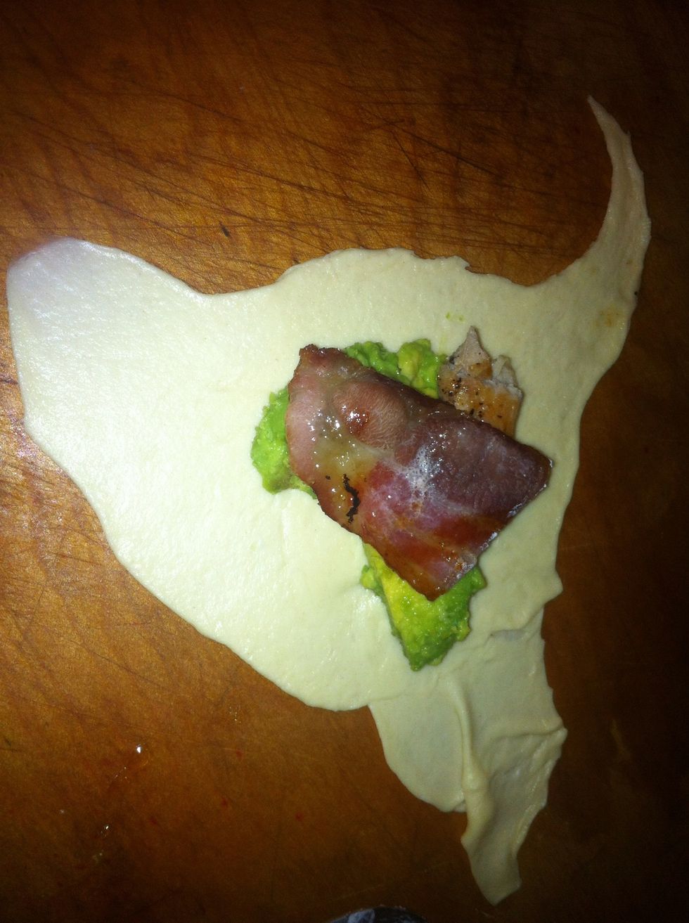 Spoon some avocado, chunk of chicken, and a little chunk of bacon onto the crescent roll.