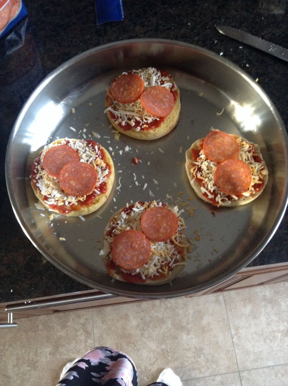 Spoon some of the pizza sauce onto each muffin. Top with mozzarella cheese and your other toppings. I chose pepperoni