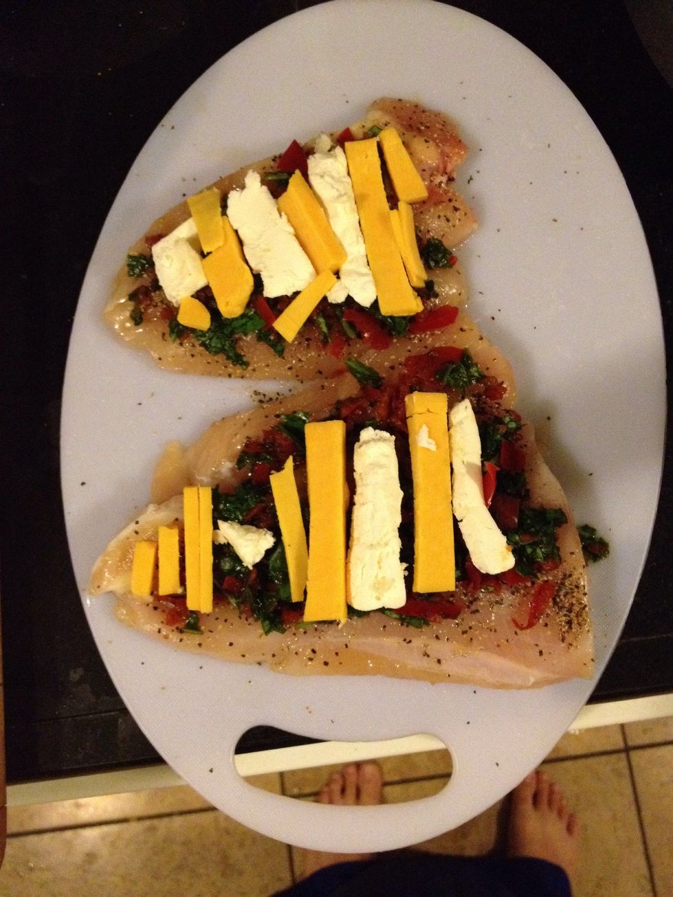 Spoon some of the spinach and red pepper bell mixture onto each one. Place a few chunk of cream cheese, cheddar cheese in chicken.