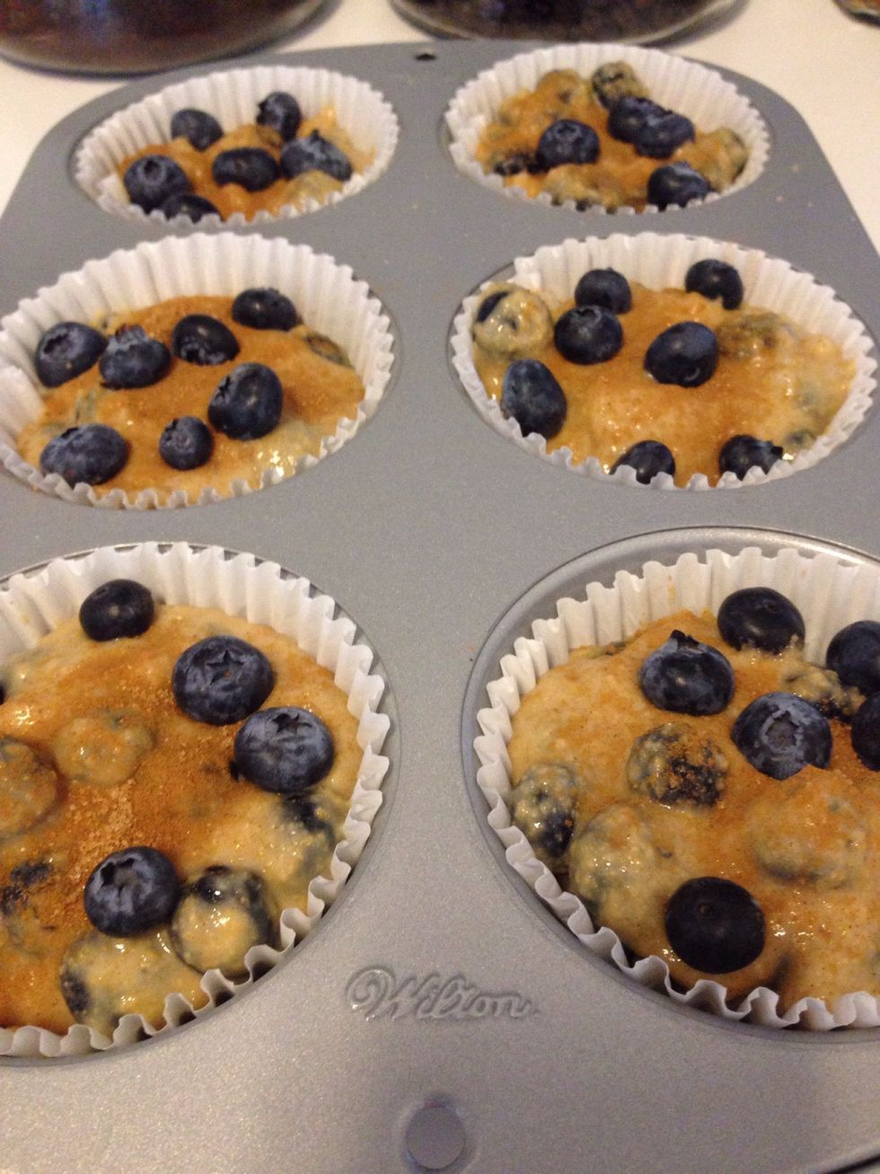 Spoon the batter into the muffin pan, lightly sprinkle with the cinnamon/sugar mixture, and press a few extra berries into the top! Bake on center oven rack for 20-30 minutes. Mine took 28 minutes.