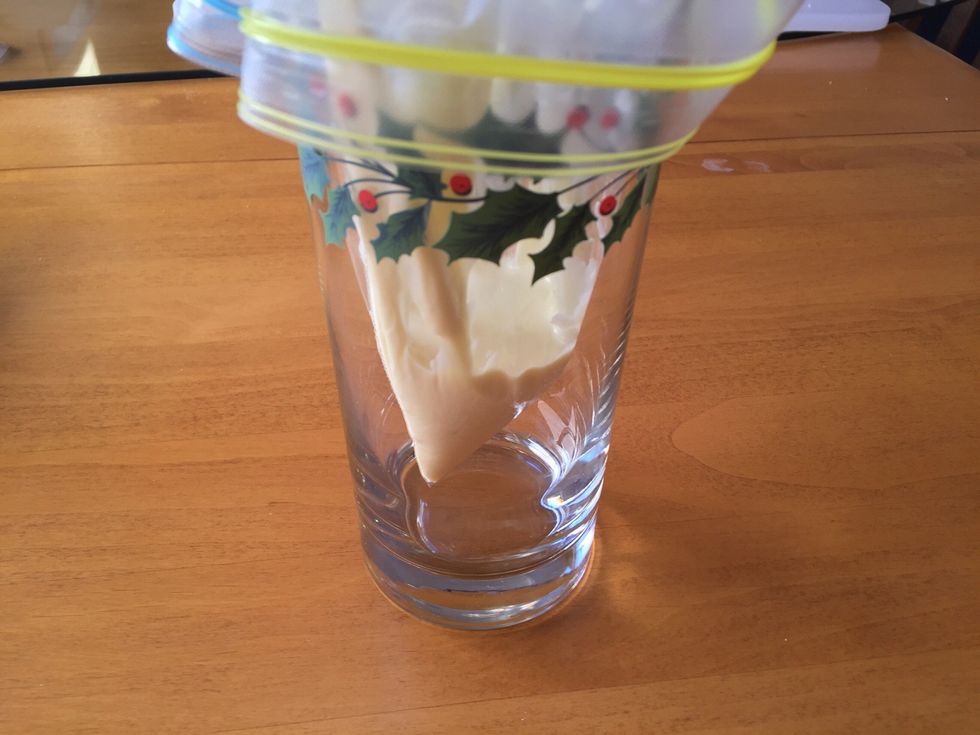 Spoon white chocolate into Ziploc bag. Snip a corner with scissors to create a makeshift pastry bag. Tip: Place the bag in a tall cup to make adding the chocolate easier.