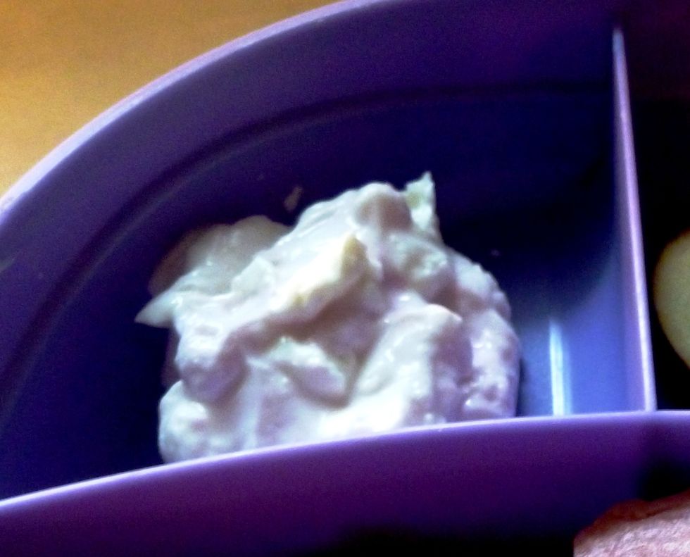 Spoon yogurt into one section of a divided dish.