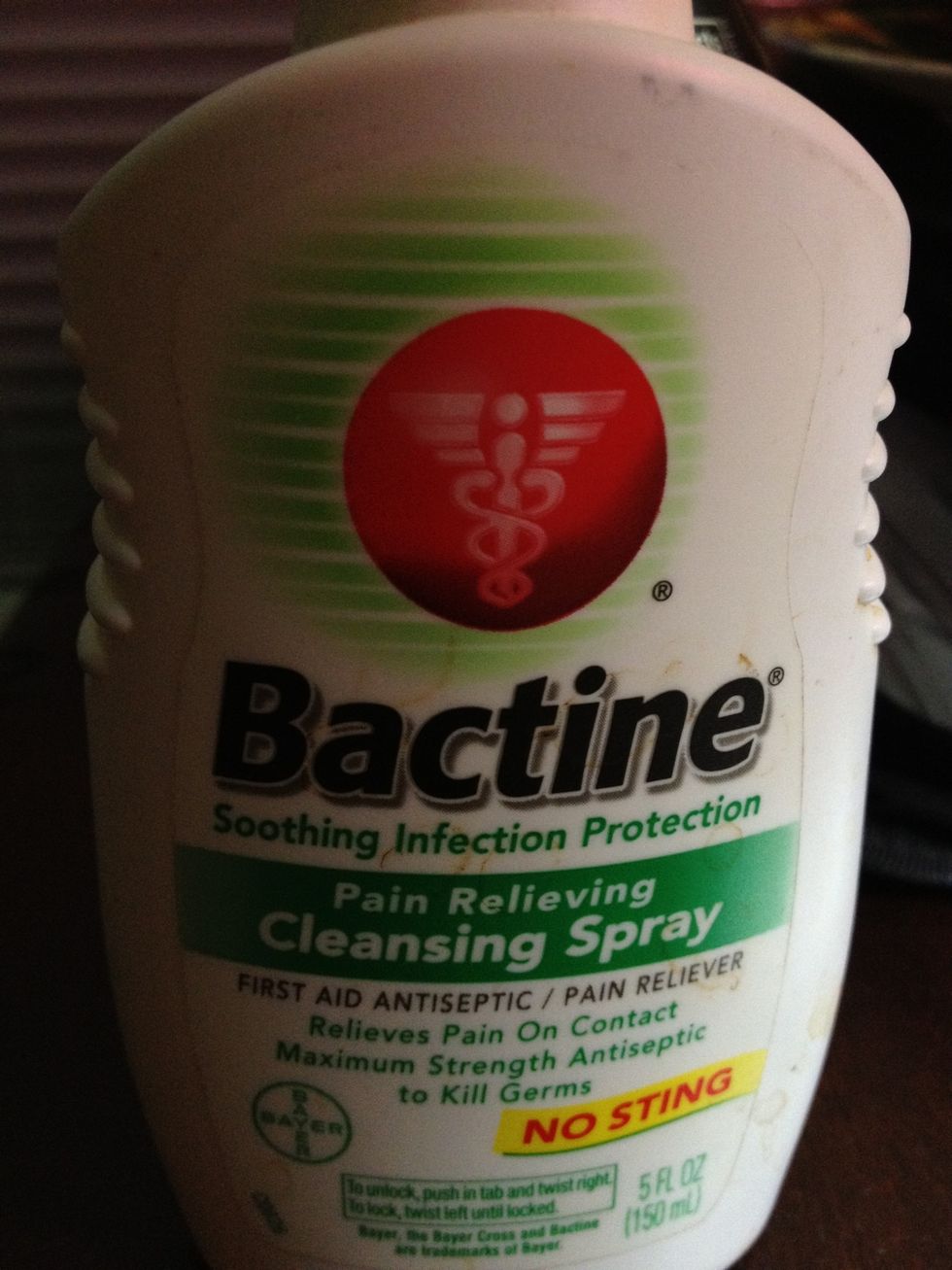 Spray a first aid antiseptic to your cut. This will keep it clean and avoid infection.