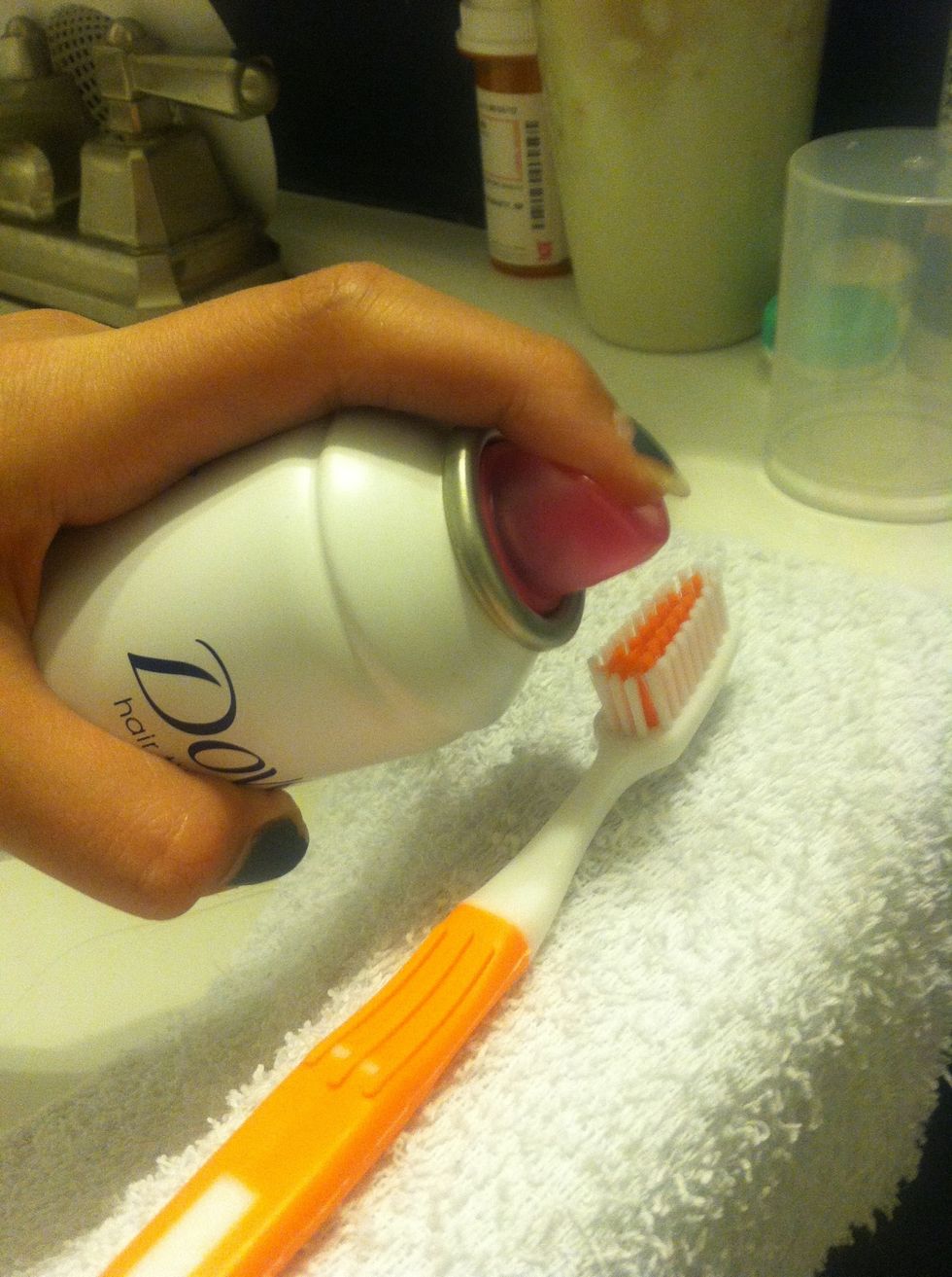 Spray a good amount of hairspray evenly on the bristles of your toothbrush.