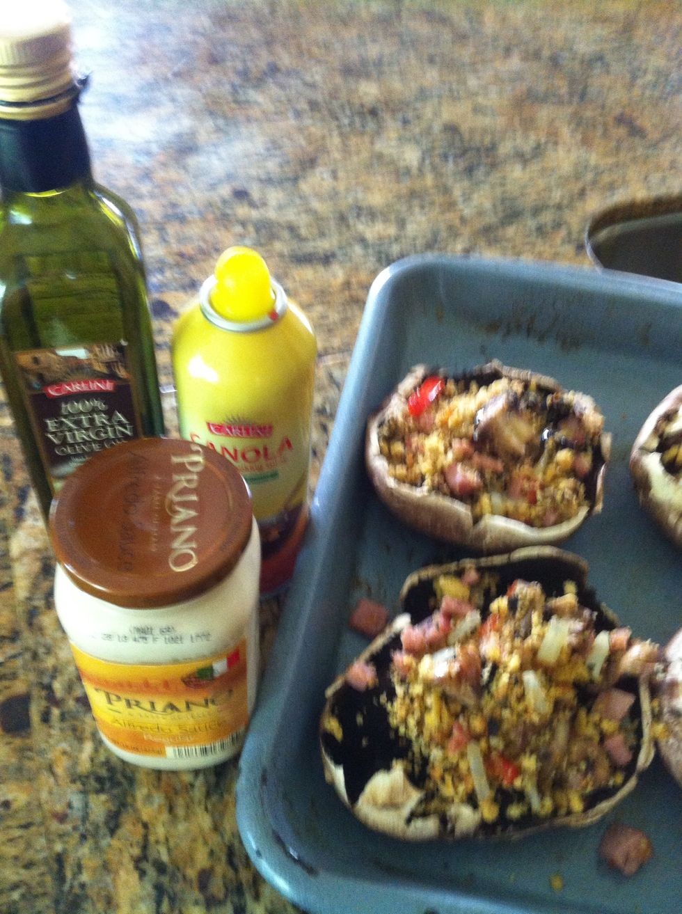 spray a oven pan .. set the mushrooms and stuff them.. add 2 spoons of sauce and top with your favorite cheese