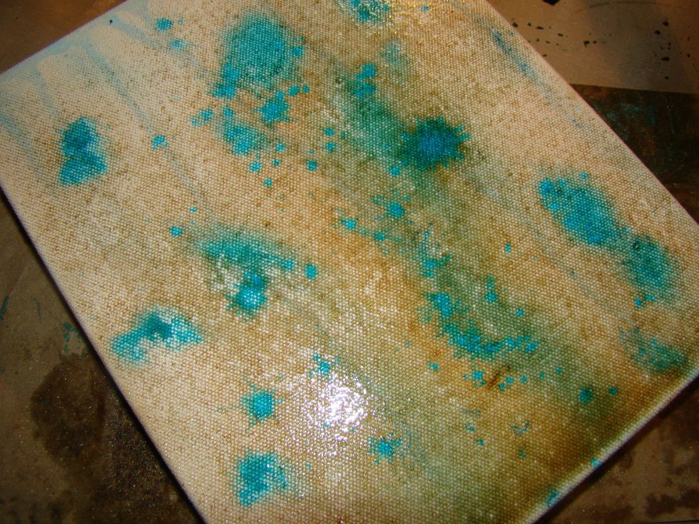 Spray away til you achieve the look you are going for. I then took a paint brush and flicked the Tibetan Poppy Teal on the canvas for splatter effect. Dry completely.