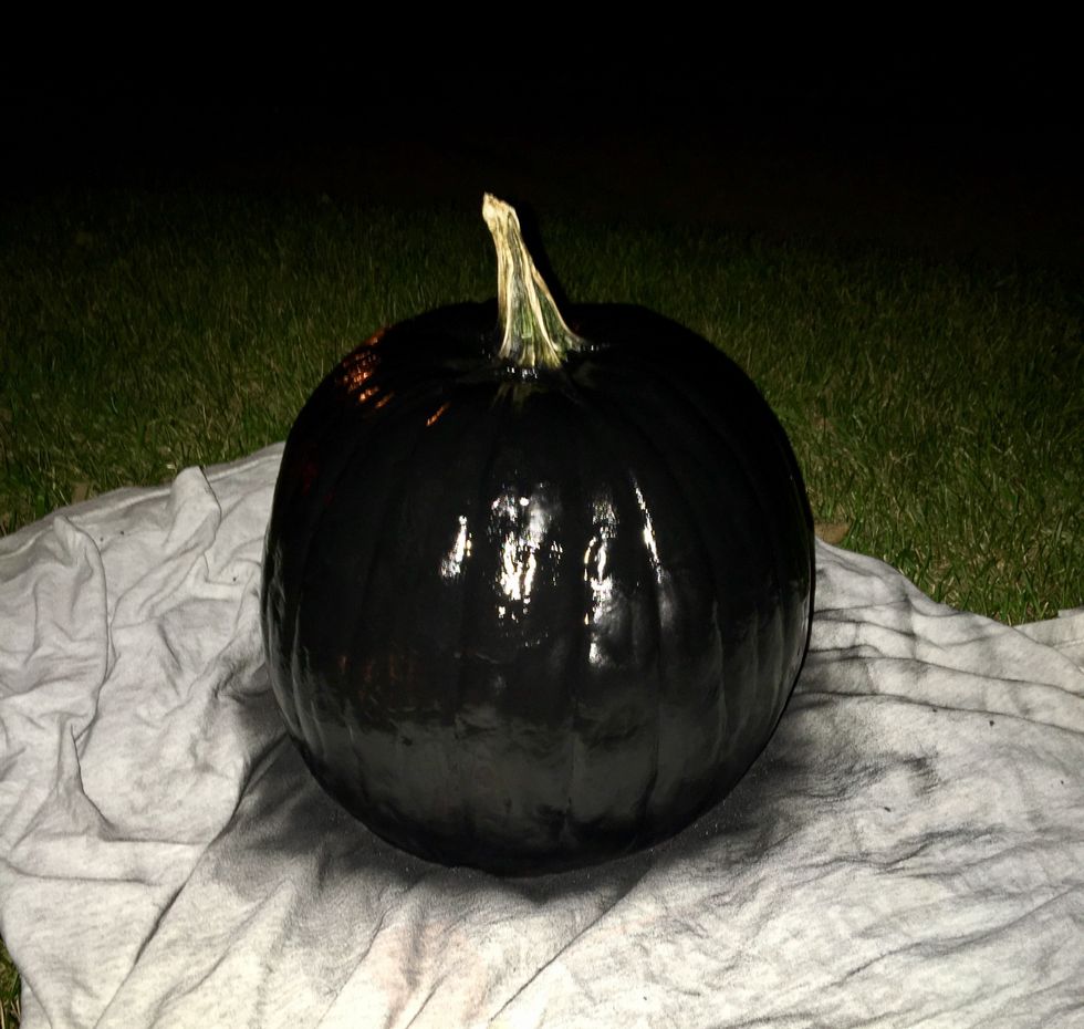 Spray black paint on the pumpkin from 1-2 feet away and apply 3-4 layers. Wait 4+ hours for paint to dry completely.