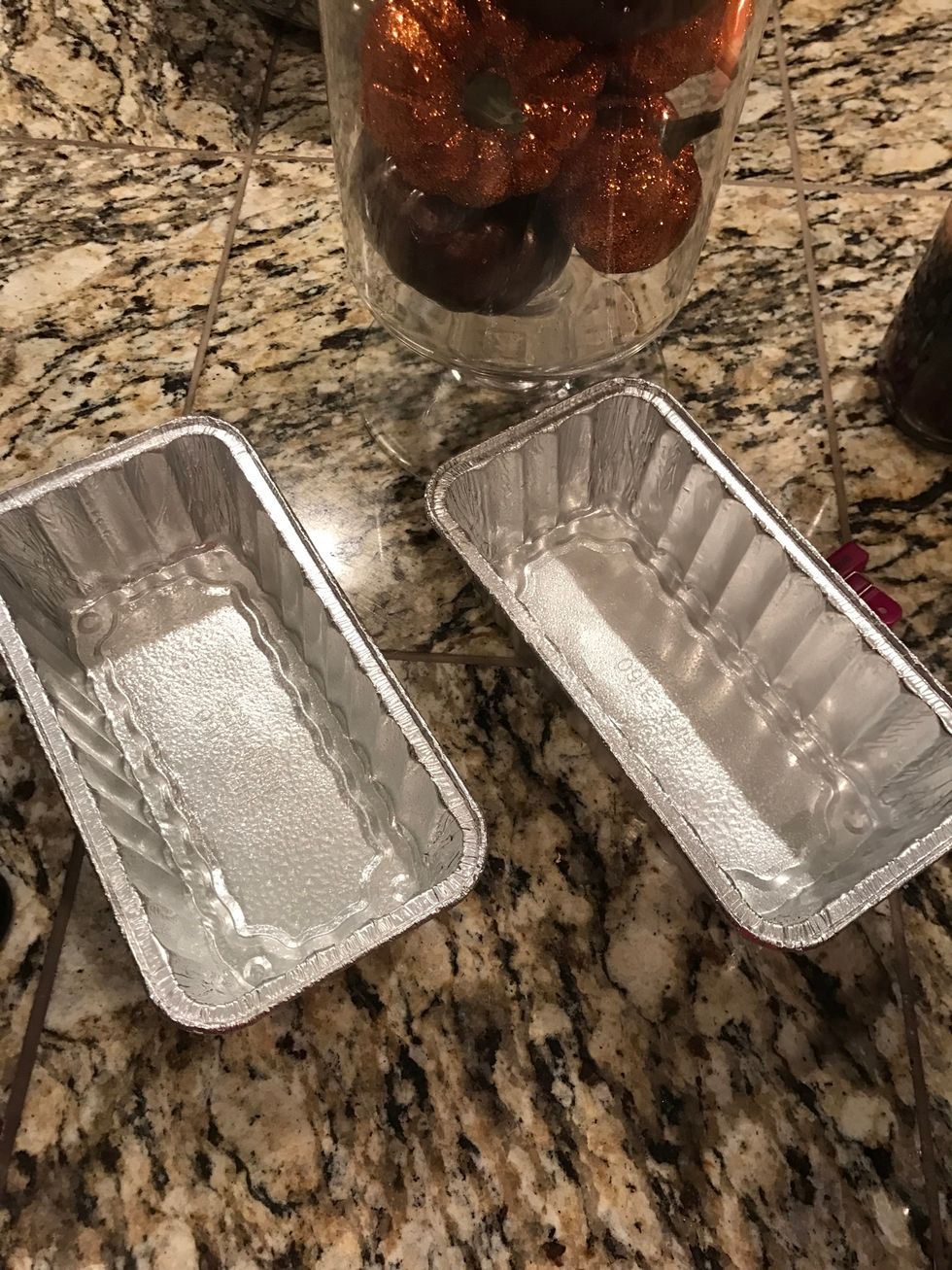 Spray bread tins with non-stick spray