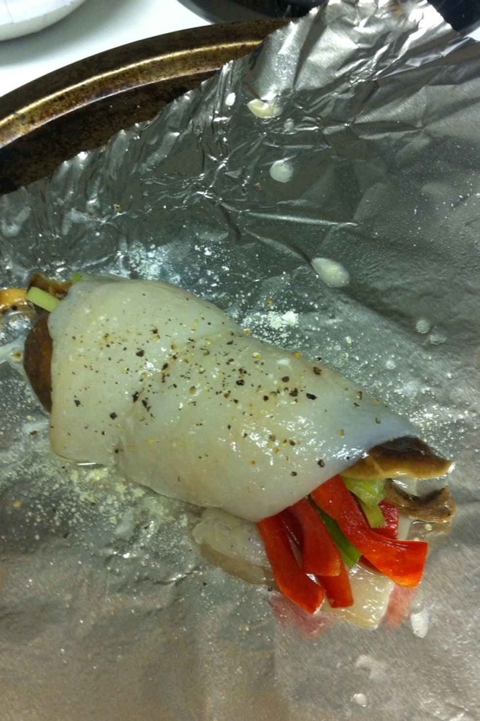 Spray cooking sheet with olive oil spray.  Place veggies on the inner part of fish.  Add about 1/4-1/5 of the mushrooms.  Roll fish. Brush fish with melted butter.  Then season with salt and pepper.