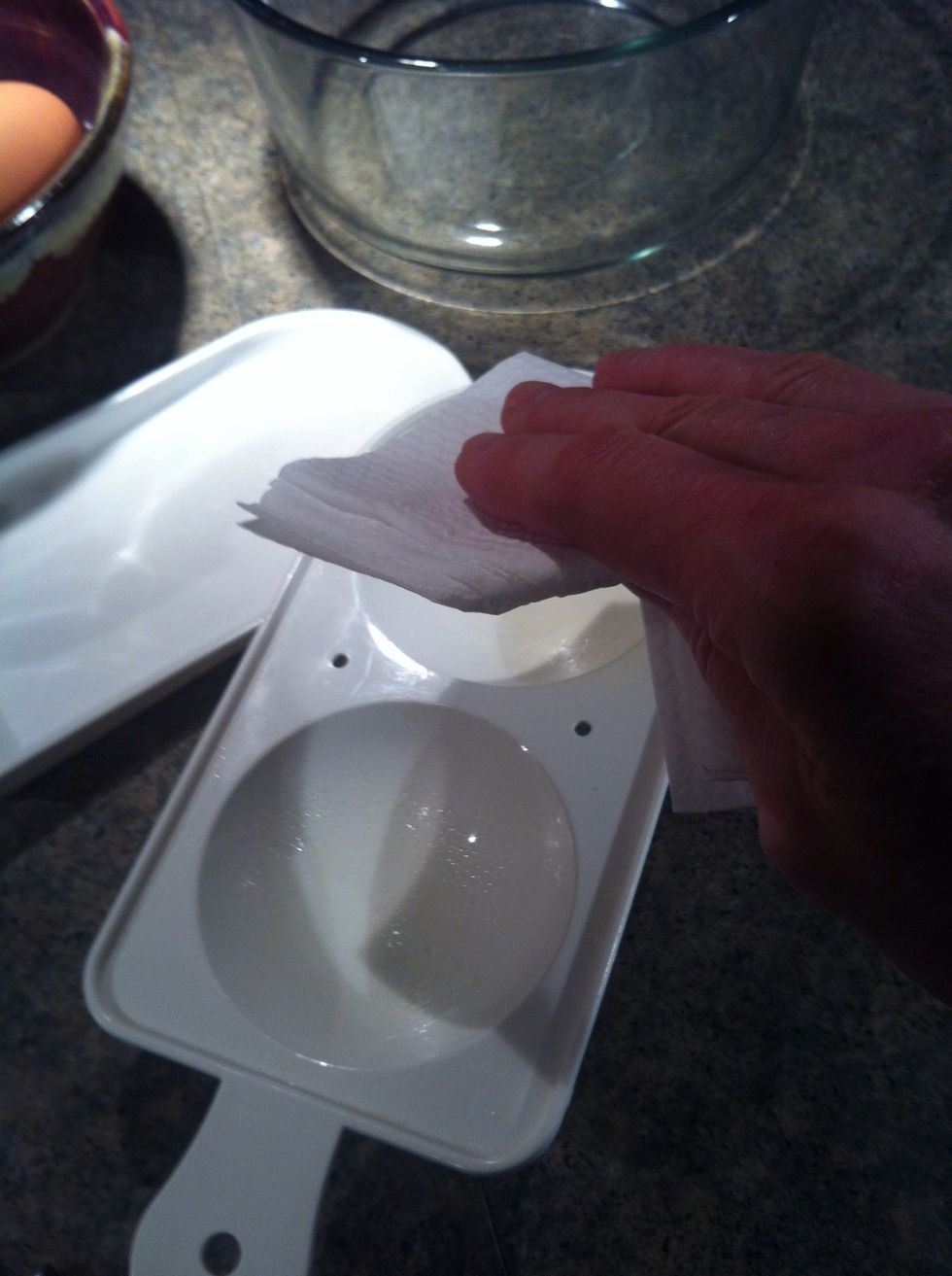 Spray egg poacher with a little Pam and wipe with towel