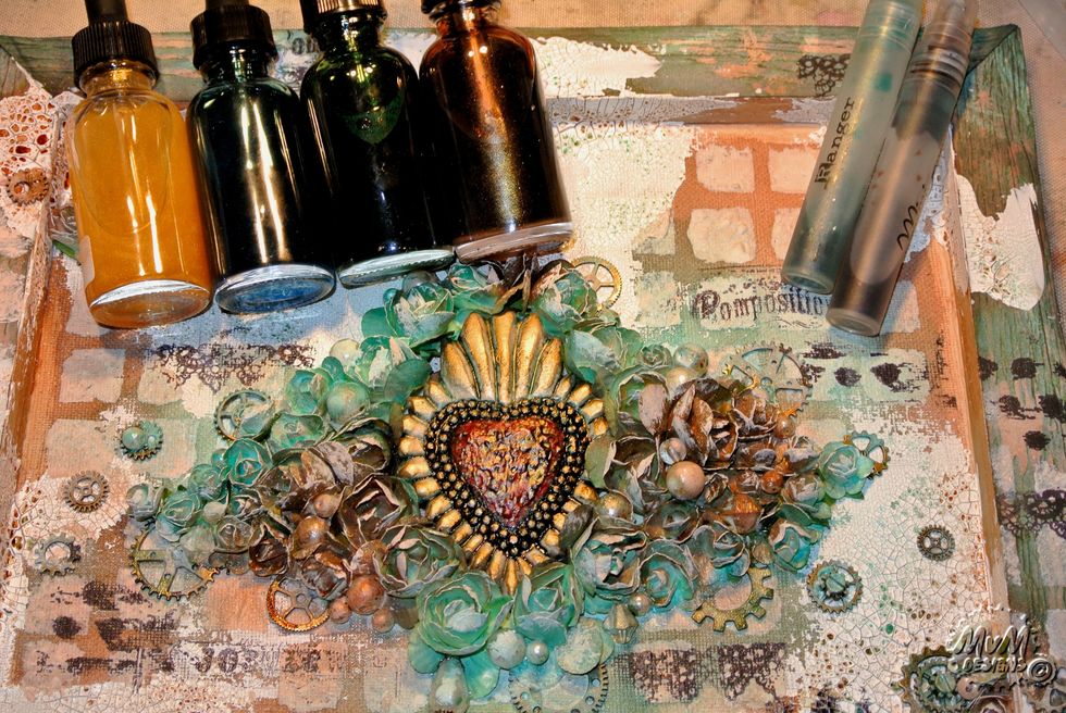 Spray everything with the Minx mixes (mix blue/green/yellow and mis brown/gold/yellow) and spray the embellishments.