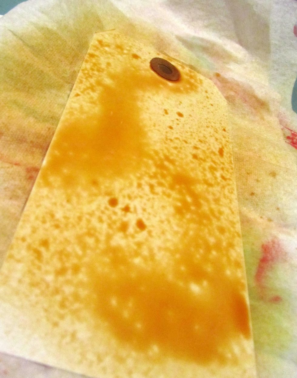 Spray generously and pic up the tag and move the color around.