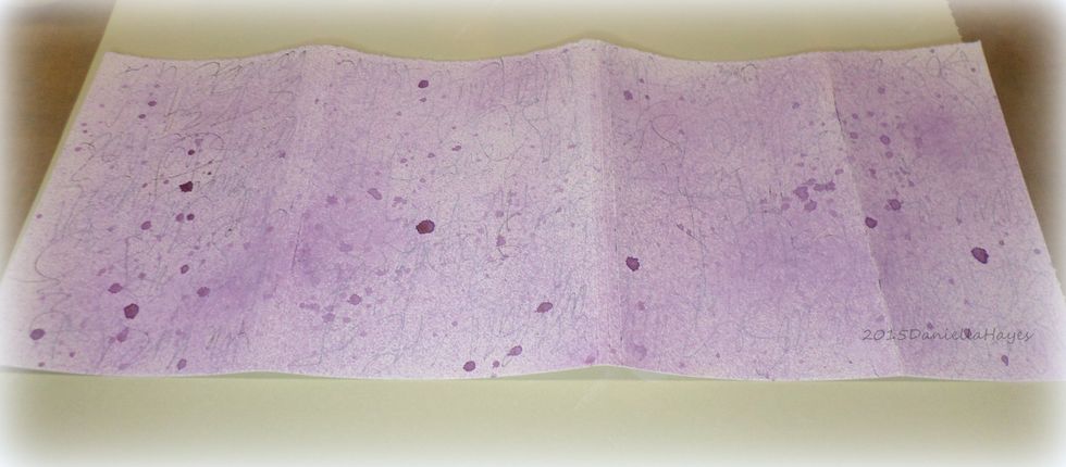 Spray ink on the front and the back sides of the cover and on the front and back sides of the pages. Let dry.