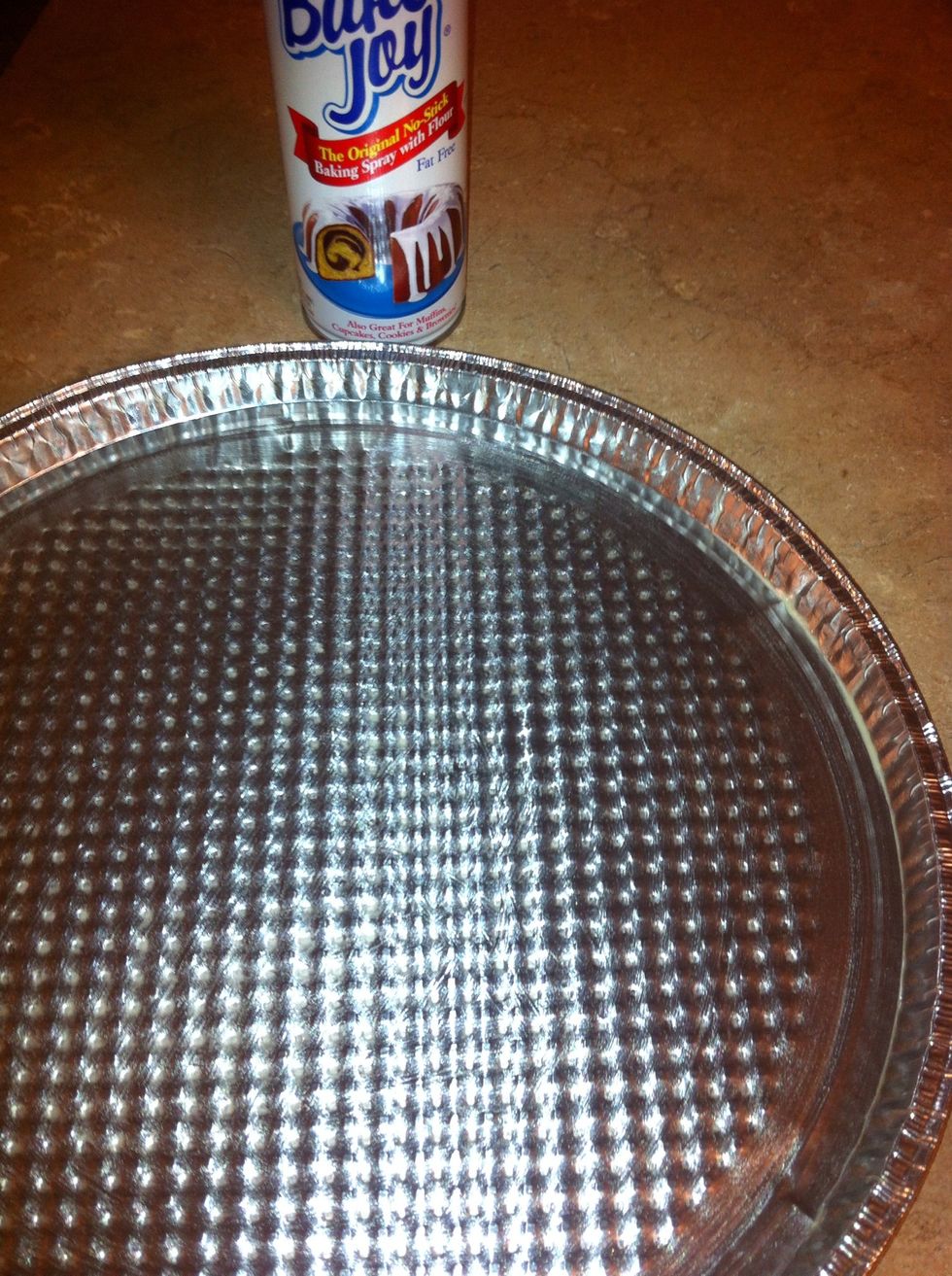 Spray pizza pan with non-stick spray.