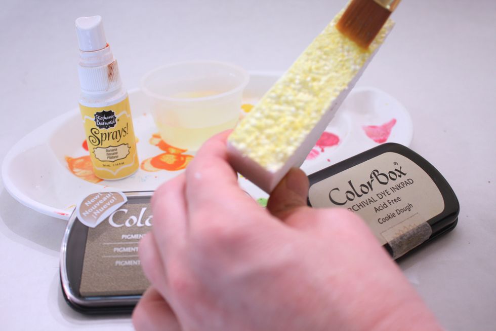 Spray some Ink spray onto your palette and get a little cup of water. Dip brush in water, then ink, then swipe on. After swiped on go back in with a stipple motion and cover all white edges