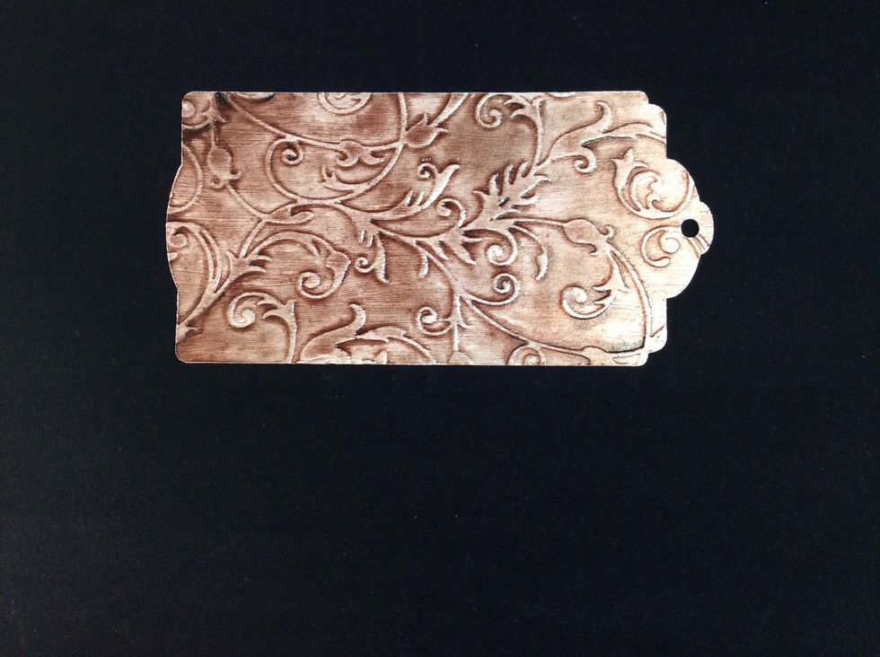 Spray tag with glimmer mist in chosen colour allow to dry. You can dry with heat gun gradually to minimise blistering .