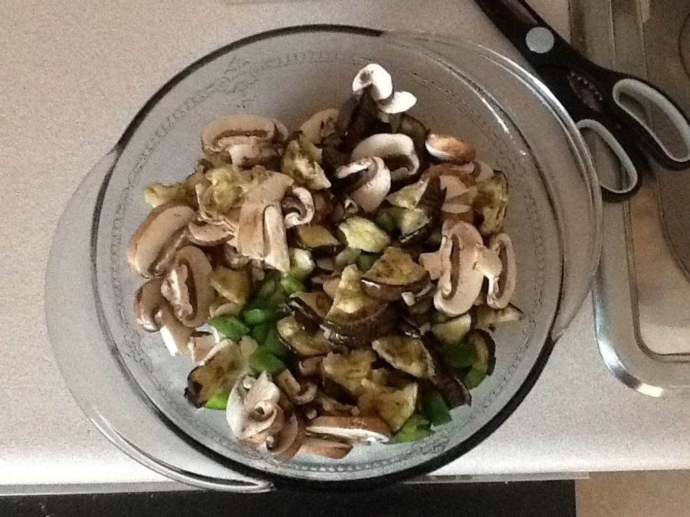 Spray the casserole dish. Mix the eggplant, green pepper, and mushroom in the dish. Add sauce and stir well.