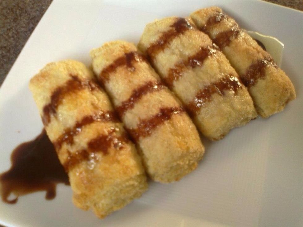 Spray the condensed milk then distribute the chocolate syrup