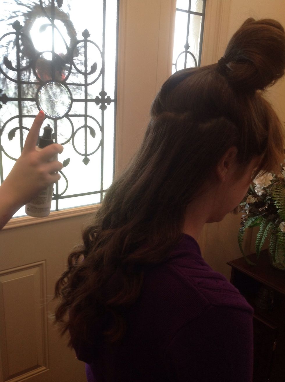 Spray the first section with a light amount of hairspray.